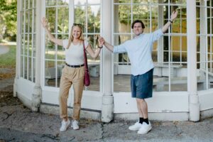 A couple poses with joyous enthusiasm at the famous gazebo in the park of Hellbrunn Palace, where iconic scenes of a classic love story were once filmed.