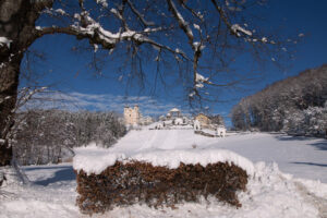 Distant view of Maria Plain pilgrimage church from a snow-covered path.