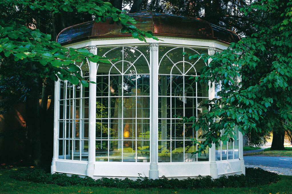 The iconic Gazebo at Hellbrunn Palace, wrapped in green foliage, stands as a charming testament to the romantic tales of the "Private Sound of Maria Tour.