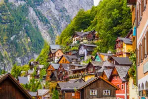 Historic buildings of Hallstatt nestled against the mountains, showcasing the village’s charm and alpine surroundings.