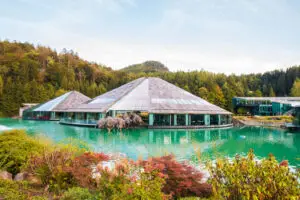 Red Bull Headquarters in Fuschl am See, surrounded by a serene lake and alpine landscape, blending modern architecture with natural beauty.