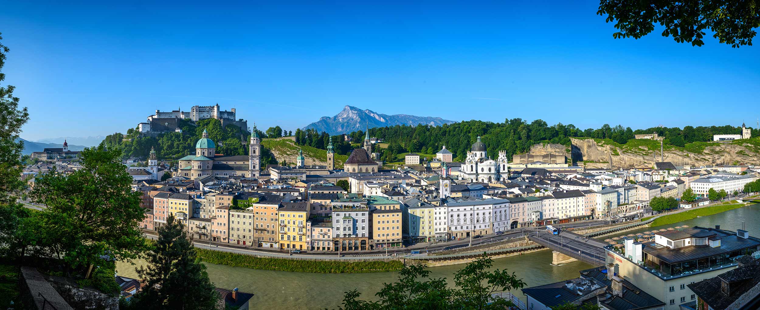 Salzburg Panorama with Fortress and Old Town Panoramic view of Salzburg with Hohensalzburg Fortress and historic Old Town under blue summer sky