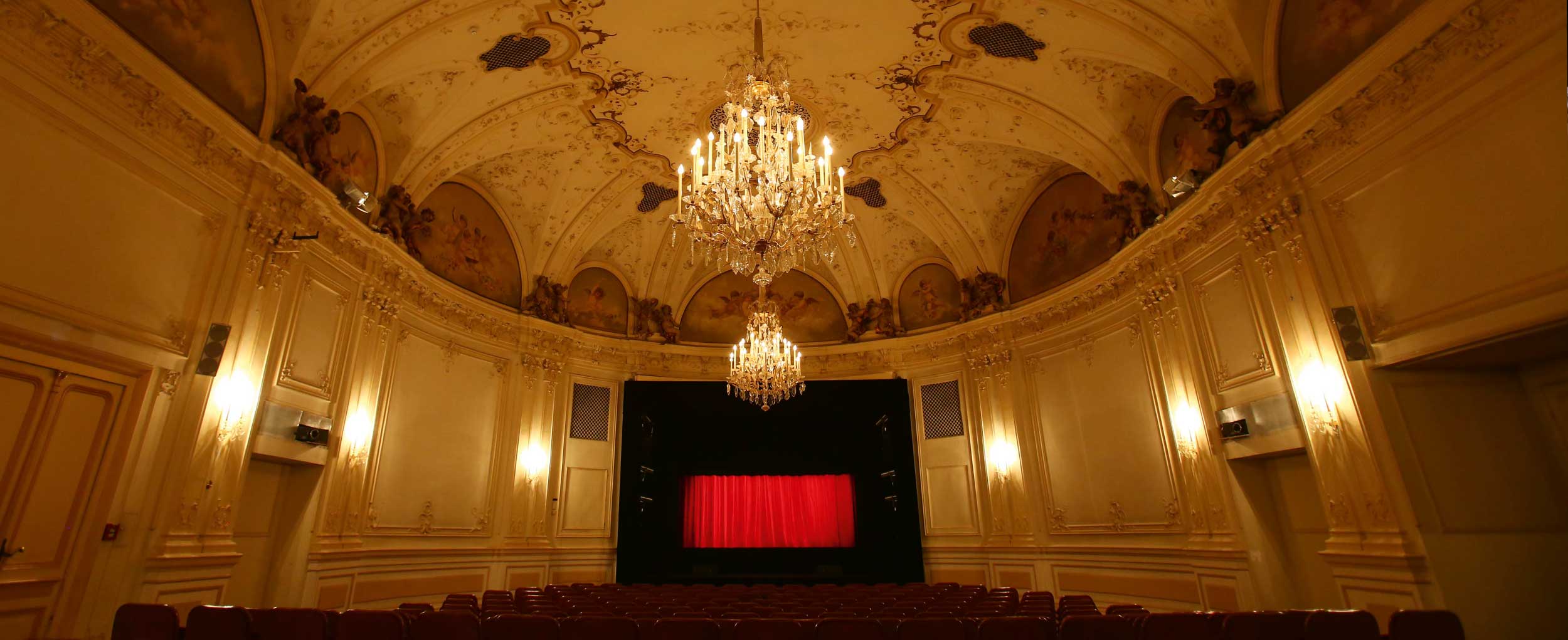 Sound of Music Salzburg Marionette Theater interior view Interior of the historic Salzburg Marionette Theater with red curtain before the Sound of Music performance